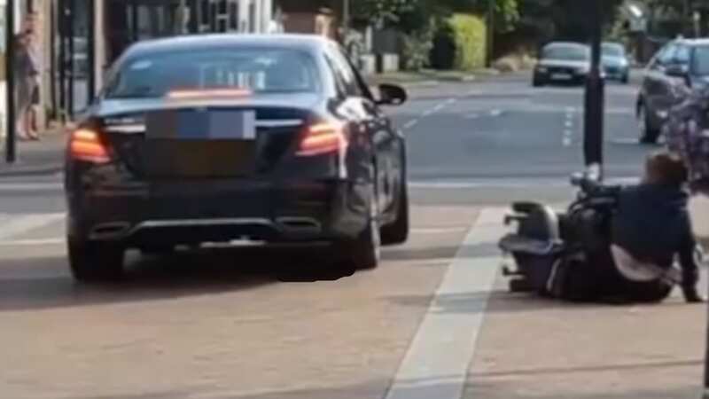 Moment Mercedes driver pushes woman off her mobility scooter in road rage row