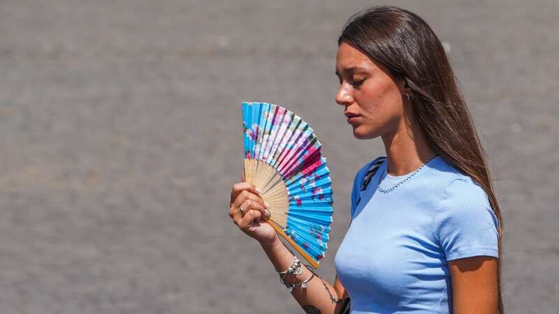 A woman cools herself in Rome (Image: Amer Ghazzal/REX/Shutterstock)