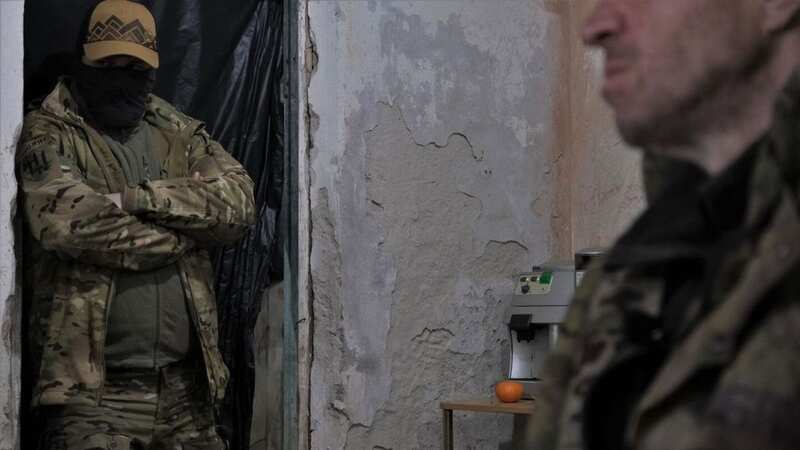 A Ukrainian serviceman observing a captured member of Russian paramilitary group Wagner (Image: AFP via Getty Images)