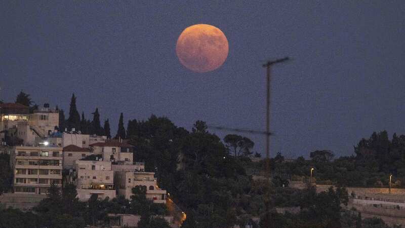The supermoon rises above the Mount of the Olives in Jerusalem (Image: AFP via Getty Images)