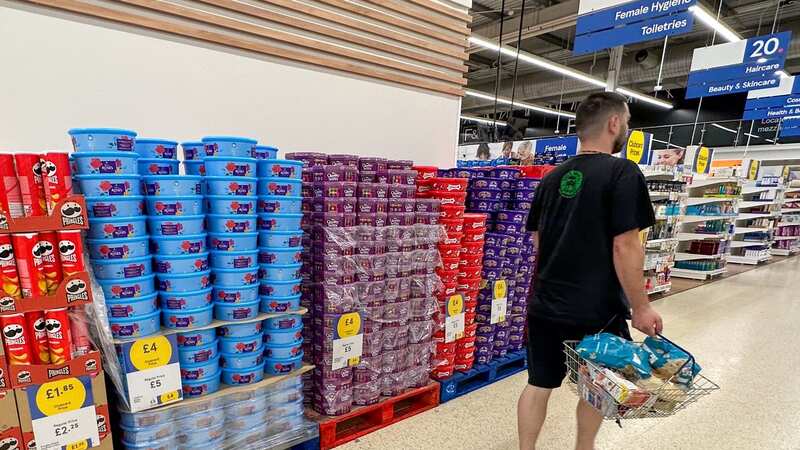 A shopper walks past a display of Christmas chocolates spotted months before the big day (Image: Bav Media)