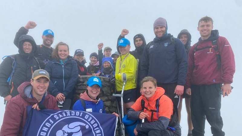 Ed Barrett (in yellow) and team at the top of Mount Snowden (Image: @EdBarrett_9/Twitter)
