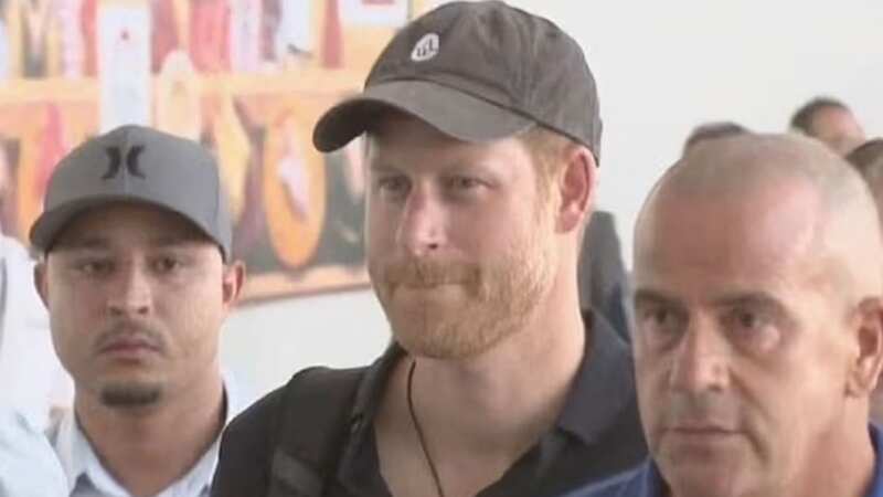 Prince Harry grins as he arrives in Tokyo alone without Meghan