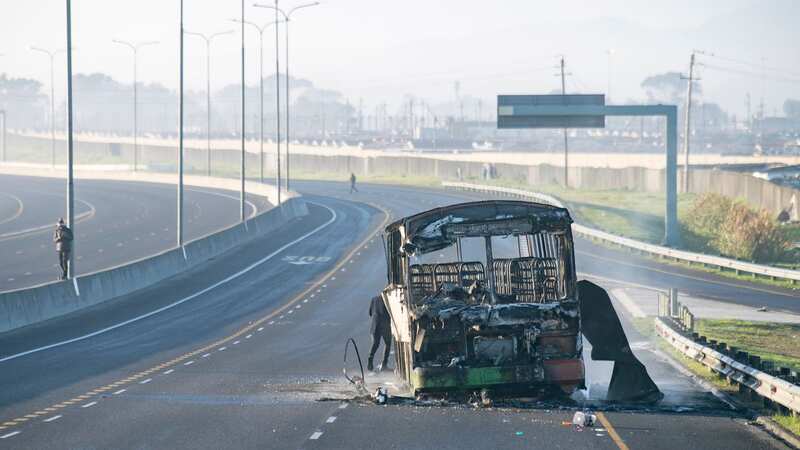 A burnt out bus on the outskirts of Cape Town, South Africa during violent protests (Image: AP)