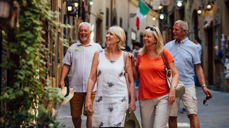 Tourists wander around cobbled streets in Italy (Image: Getty Images)