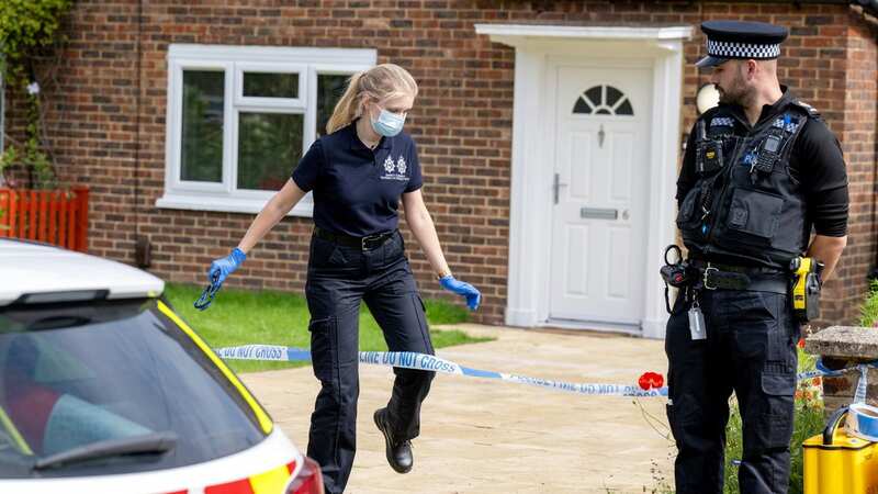 Police outside the address in Woking where a girl, 10, was found dead (Image: Tony Kershaw / SWNS)