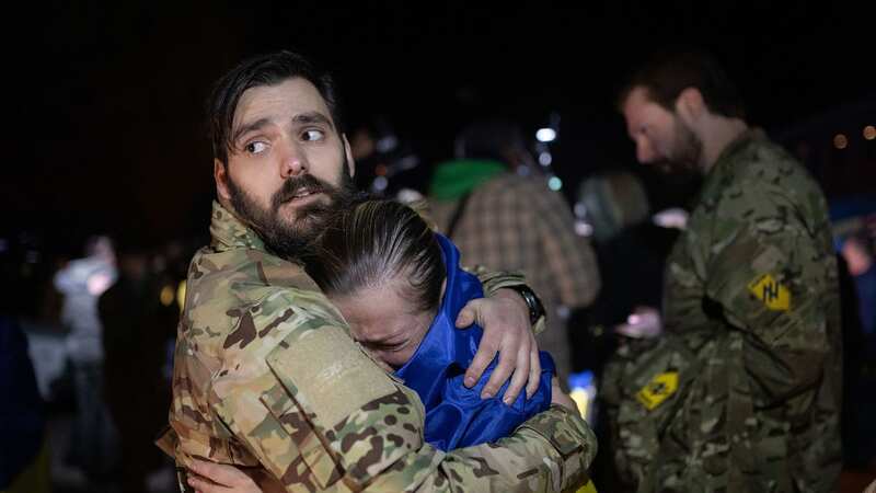 A woman released from Russian captivity is hugged as she arrives to Ukraine (Image: Ukrainian President Press Office/UPI/REX/Shutterstock)