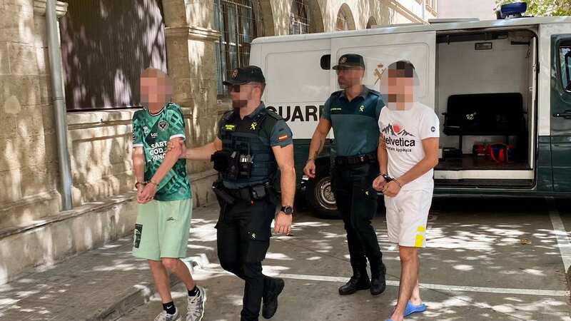 Two of the suspects in handcuffs (Image: SOLARPIX.COM-G.Esteban)