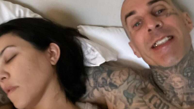 Travis Barker plants a loving kiss on Kourtney Kardashian