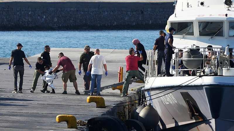 A child was escorted by coast guard officers after a migrant rescue operation on Monday (Image: AP)