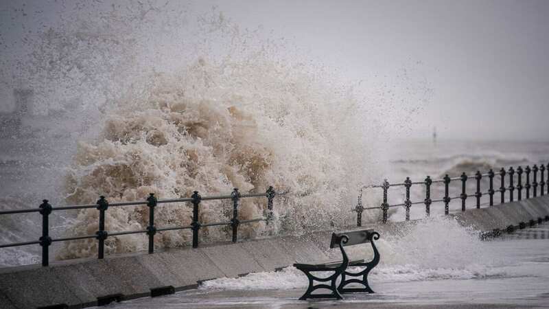 Waves whipped up by the wind against the sea wall (Image: Getty Images)