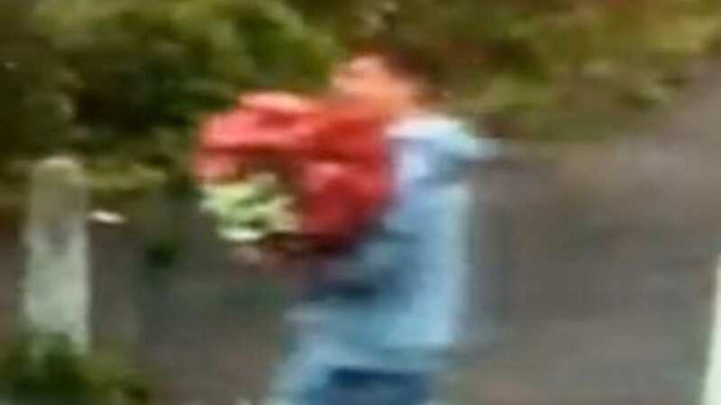 Shameless thief waves at CCTV while stealing flower display from family business