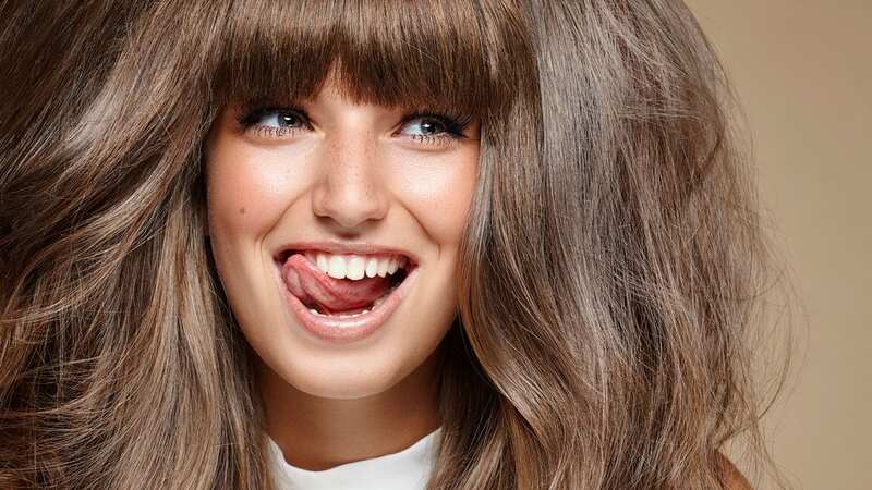 studio portrait of young brunette making faces
