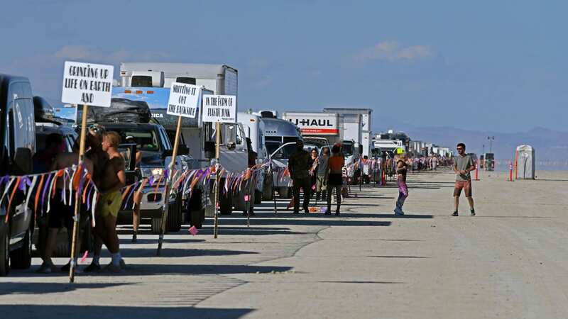 Attendees started fleeing the city on Monday afternoon at Black Rock City after being trapped for days by severe flooding and muddy weather (Image: AP)