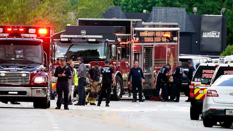 Dozens of emergency service vehicles at the scene in Pompano Beach, Florida, after the helicopter burst into flames and crashed into an apartment (Image: AP)