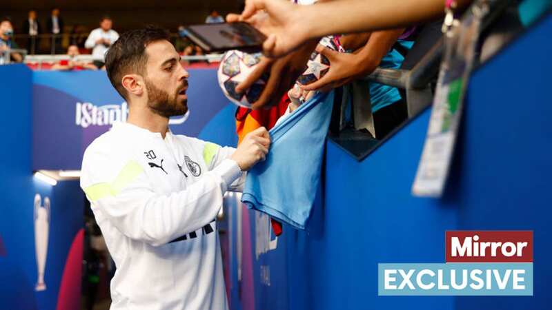 Man City star Bernardo Silva signs autographs for fans (Image: UEFA via Getty Images)