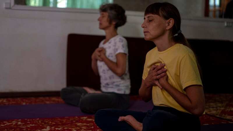 Viktoria Omelchenko, right, is practising yoga near the front-line of the conflict between Ukraine and Russia (Image: AP)