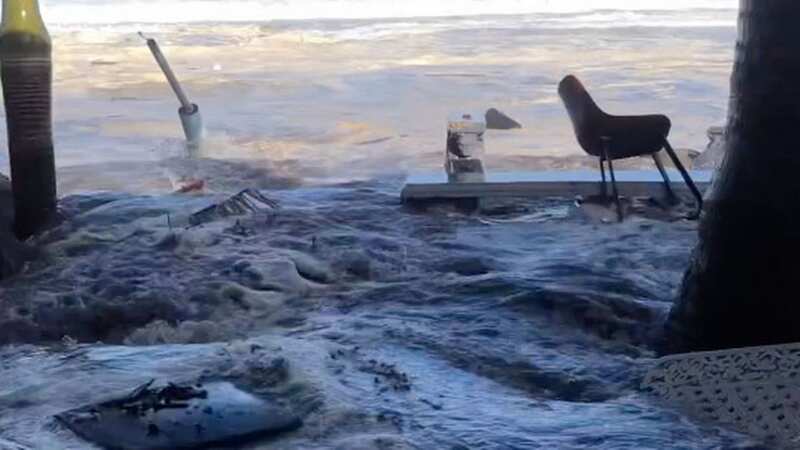 Terrifying moment enormous freak wave crashes into beachfront restaurant