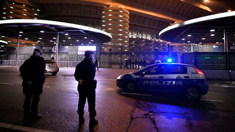 Police stand outside Milan
