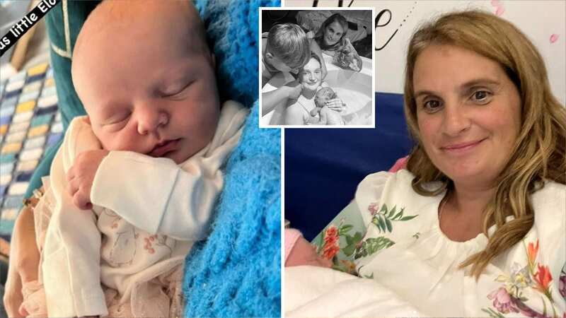 Sue Radford cuddles new grandchild after helping daughter Millie during labour