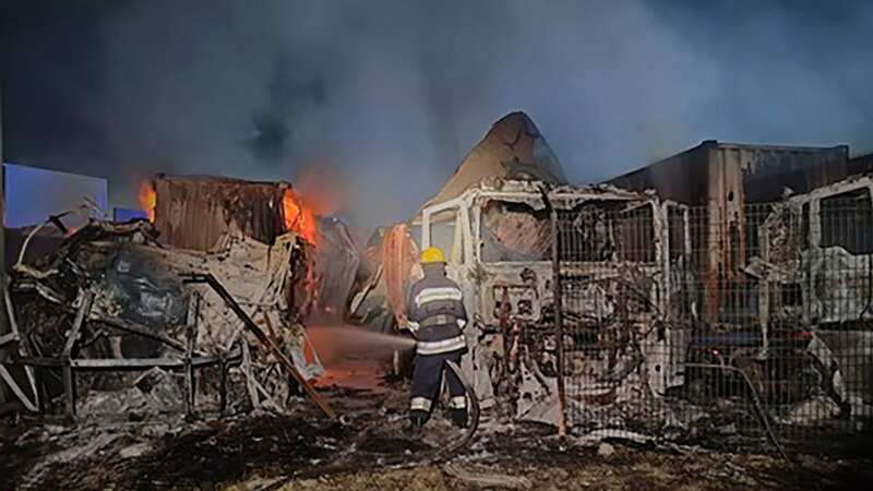 Firefighters work to extinguish the fire following the strike at the port (Image: AP)