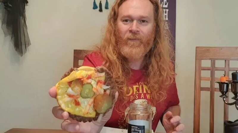 Julian shows the apparent bite missing from the burger (Image: YouTube)