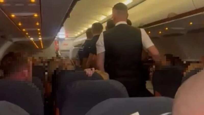The passengers were escorted off the plane (Image: Liverpool Echo/Submitted)