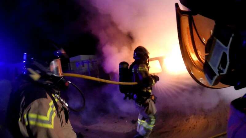 Firefighters battle to put out flames in car used in the attempted jail escape (Image: SOLARPIX.COM)
