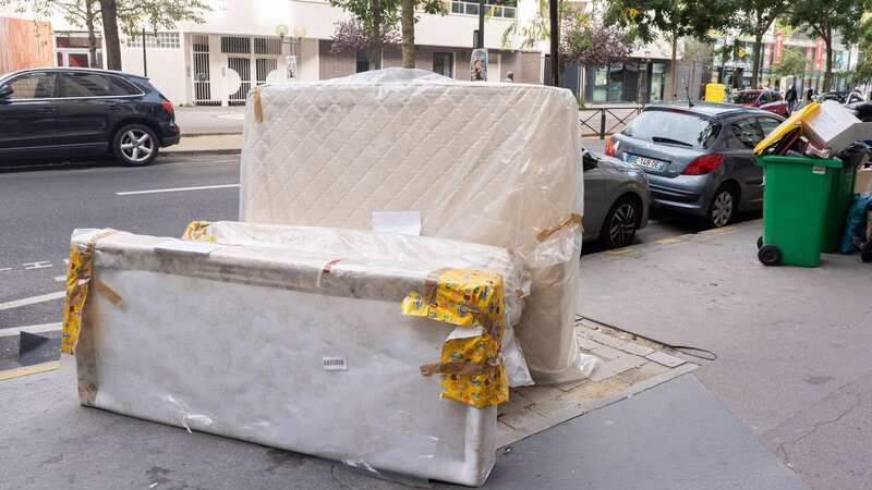 A contaminated mattress and bed frame in a street in Paris awaiting rubbish collection (Image: Bloomberg via Getty Images)