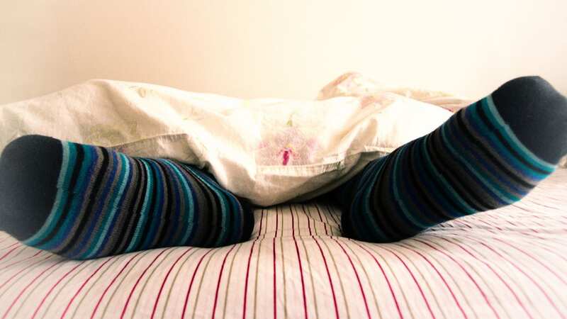 Keeping your feet warm at night could help improve your sleep (stock photo) (Image: Getty Images/iStockphoto)