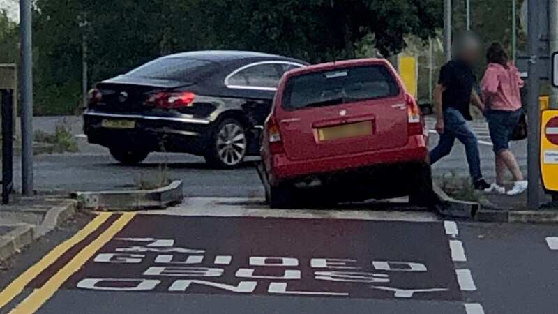 A car gets stuck in the bus lane trap at the junction in St Ives (Image: SWNS)