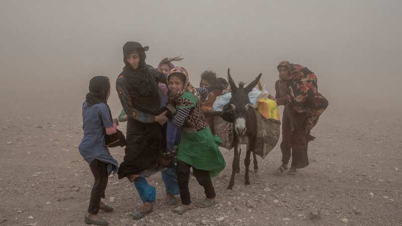 People carrying aid to tents following an earthquake in Zenda Jan district, Afghanistan (Image: AP)