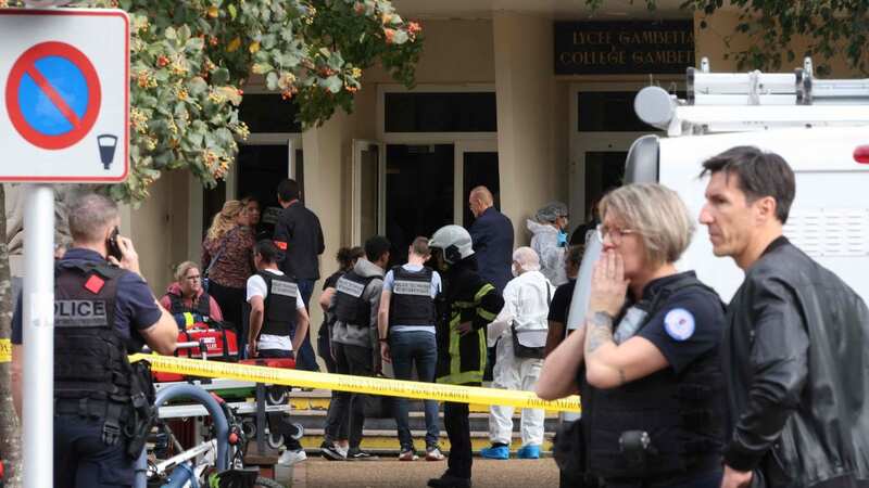 French police officers from the forensic service stand in front of the Gambetta high school (Image: AFP via Getty Images)
