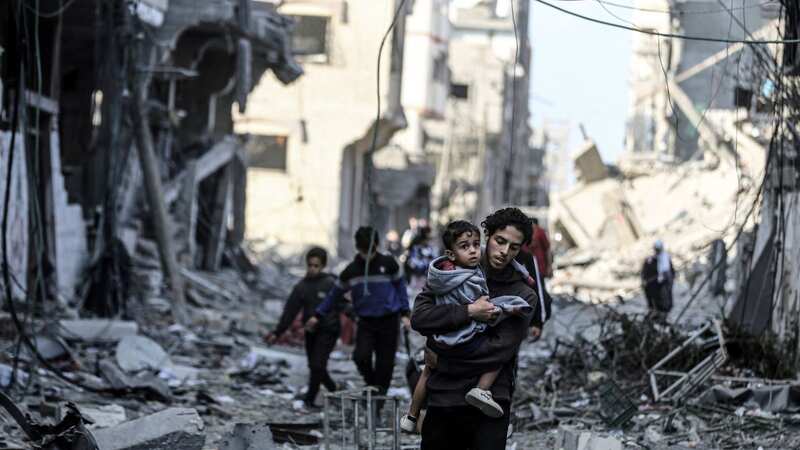 Palestinians carrying belongings flee to safer areas (Image: Anadolu via Getty Images)