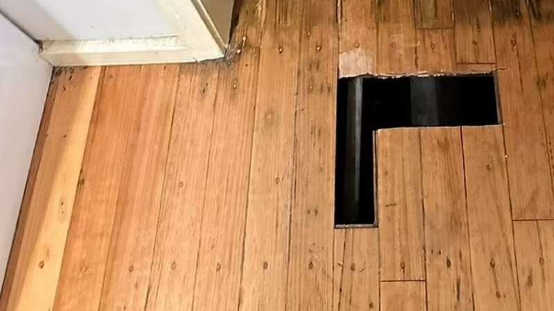 The hole in the wooden floor of the Melbourne rental property after the woman alleges she fell through (Image: Slater and Gordon)