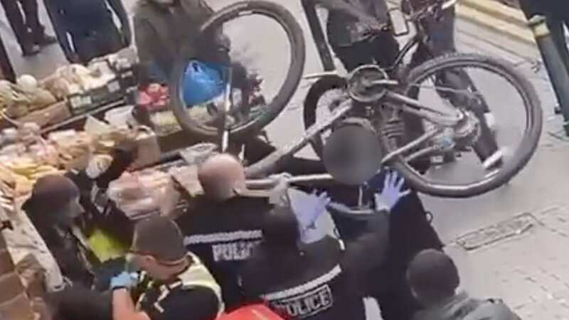 Heroic dad wrestles suspect to ground after three cops are battered with bike