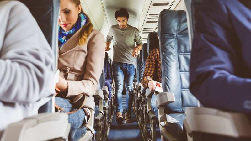 The tall man ended up being taken off the plane (Image: Getty Images)