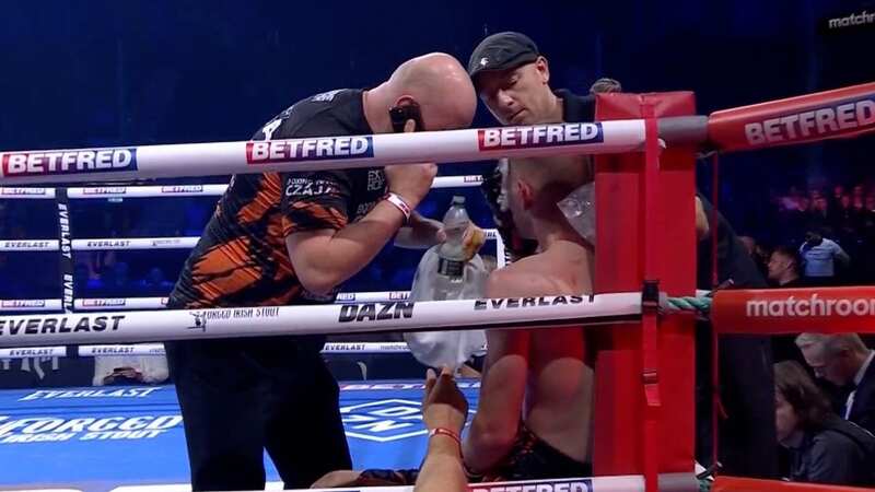 The trainer was spotted speaking on the phone during the fight (Image: @DAZNBoxing / Twitter)
