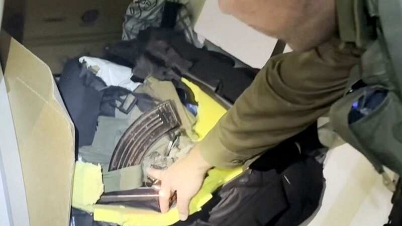 Lt. Col. Jonathan Conricus, an Israeli military spokesman, points to a cache weapons the IDF says were found in an MRI center at the al-Shifa hospital in Gaza City (Image: AP)