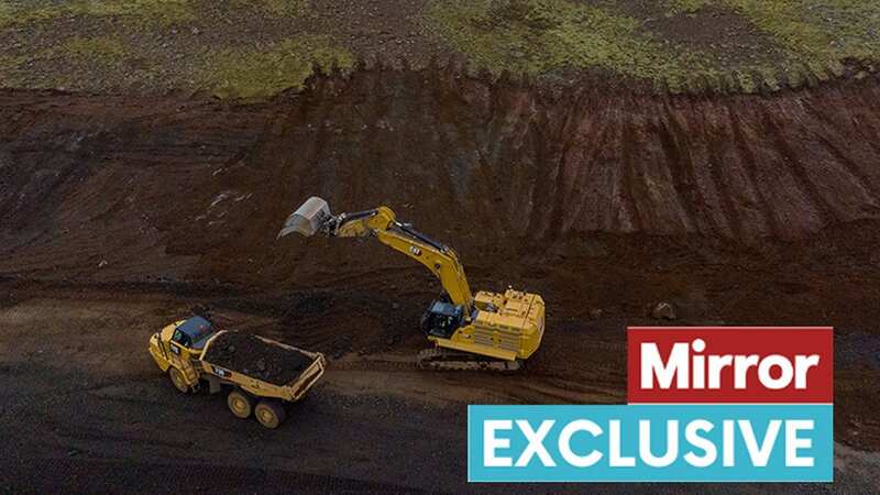 Heavy machinery working tirelessly to build a wall in Icelandic town Grindavik to help channel the lava if an eruption was to occur (Image: Andy Commins / Daily Mirror)