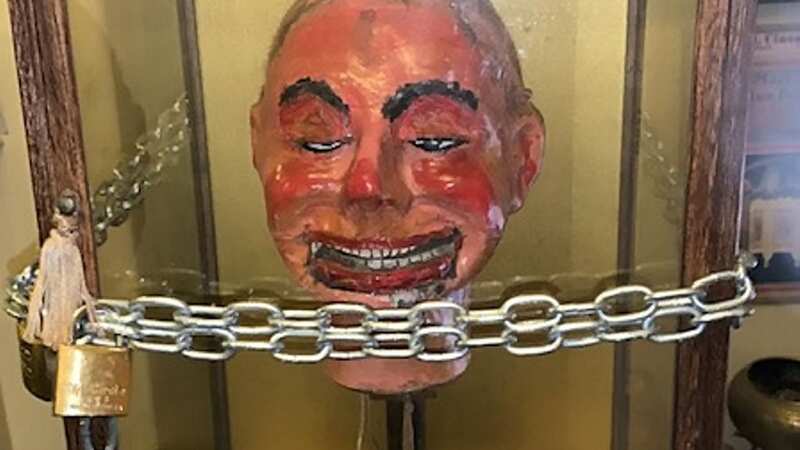 Mr. Fritz chained in his case after seeing video of the doll blinking and moving its mouth (Image: Michael Diamond /SWNS.COM)
