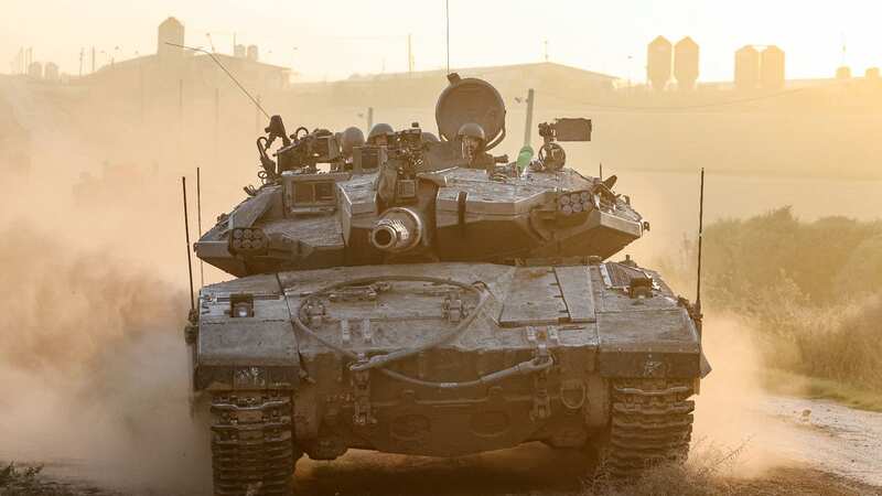 An Israeli military tank rolls near the border with the Gaza Strip (Image: AFP via Getty Images)