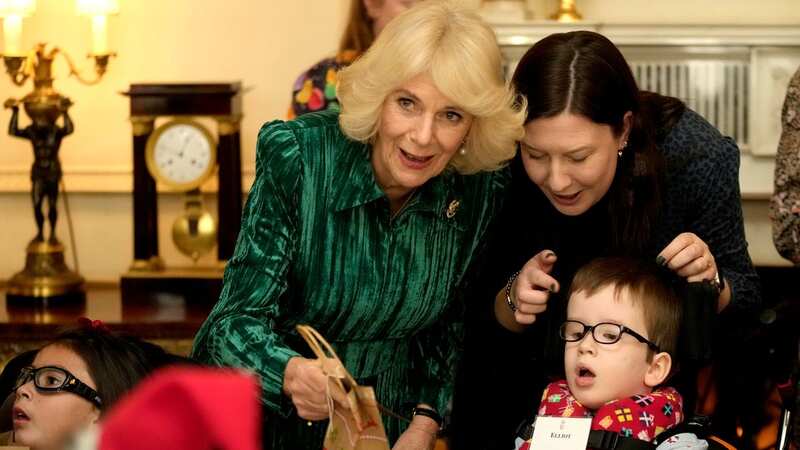 Camilla plays dinner lady as she hosts touching Christmas party for children
