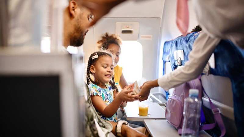 Even with an endless choice of films, keeping kids entertained on long flights can feel impossible (stock photo) (Image: Getty Images)