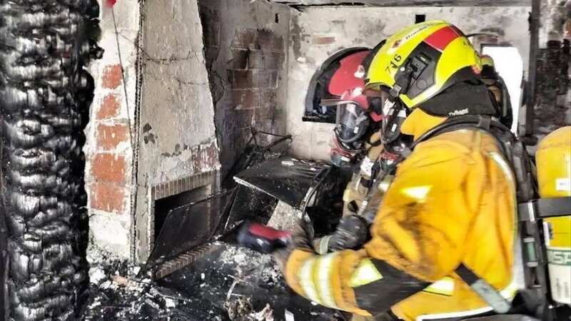 Firefighters inside the burnt out property in the Costa Blanca resort of Denia near Benidorm (Image: SOLARPIX.COM)