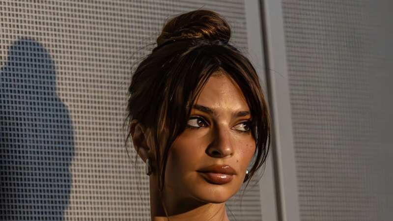 Emily Ratajkowski risks wardrobe malfunction as she dances in backless dress