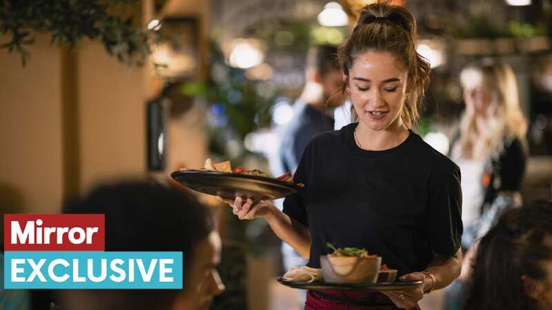 A waitress serving customers food at a restaurant
