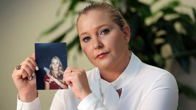 Virginia Roberts holds a photo of herself at age 16, when she says Palm Beach multimillionaire Jeffrey Epstein began abusing her sexually (Image: TNS via Getty Images)