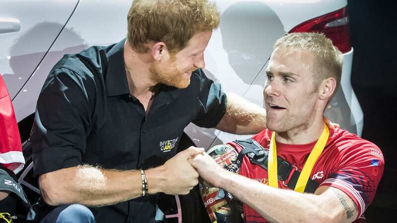 Ex-Marine and triple amputee Mark Ormrod with Prince Harry (Image: PA)