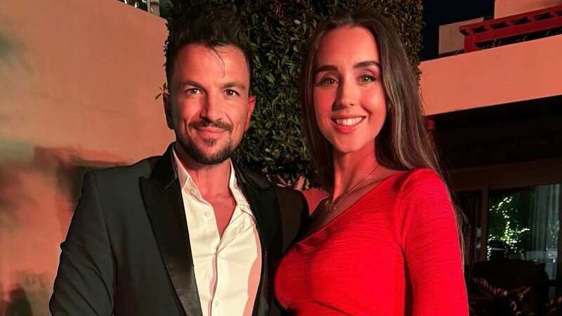 Pregnant Emily Andre cradles bump in bikini as fans predict new baby